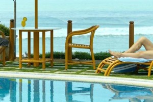 Guests relaxing by the pool and sea