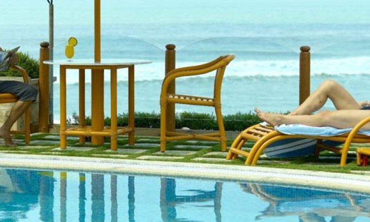 Guests relaxing by the pool and sea